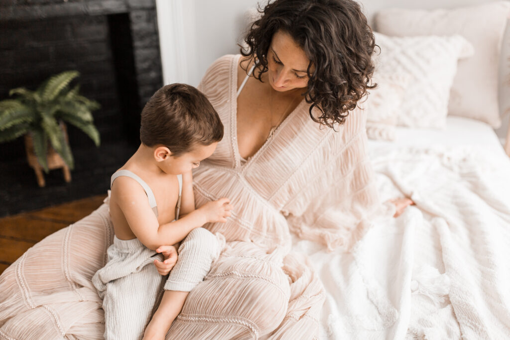 pregnant mom and son touching her belly by dc maternity photographer
